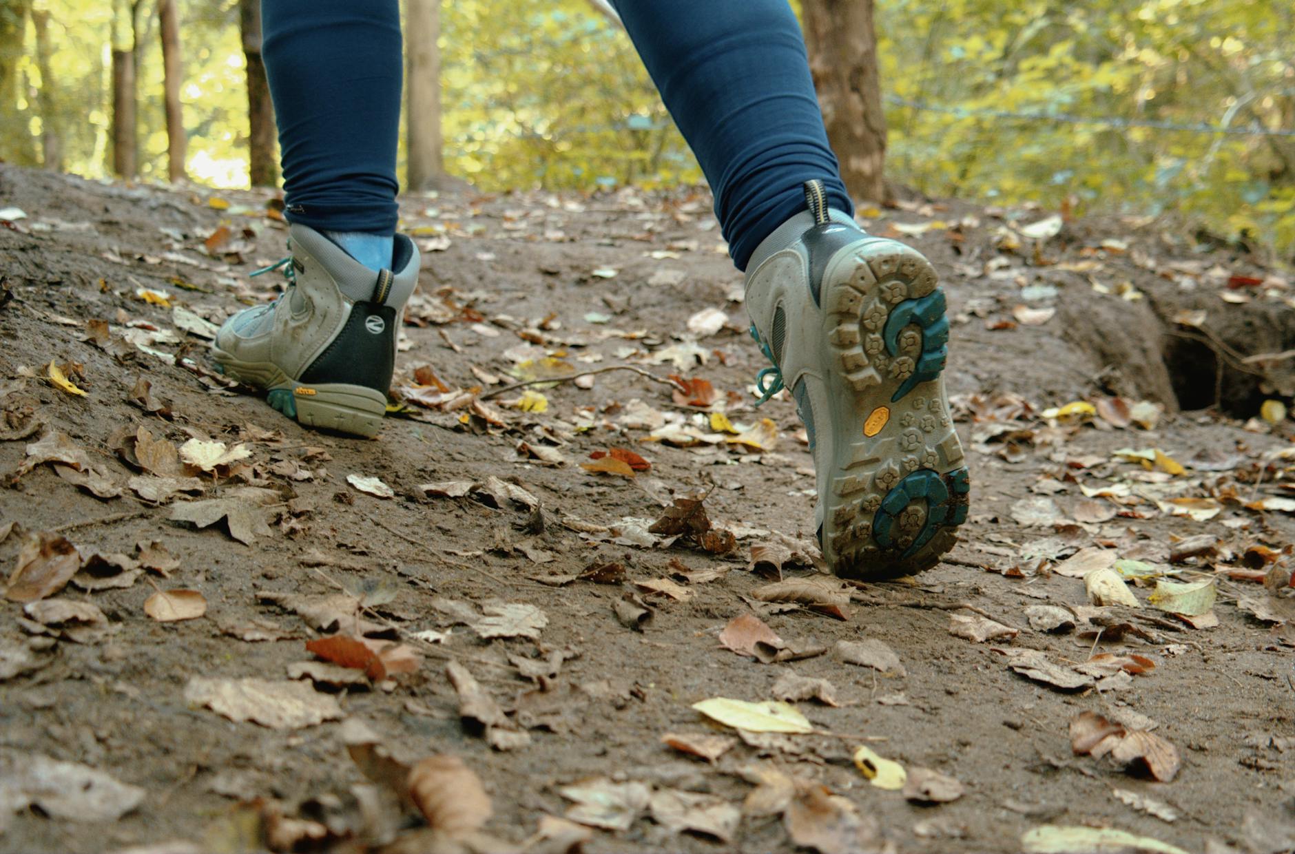 a person wearing trekking shoes walking